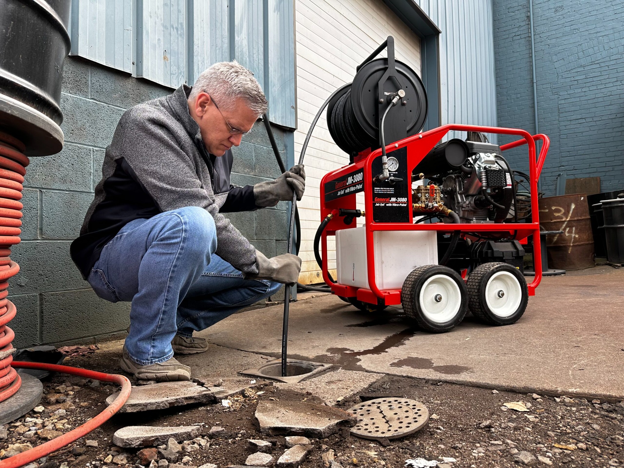 High pressure drain jetting equipment clearing a drain